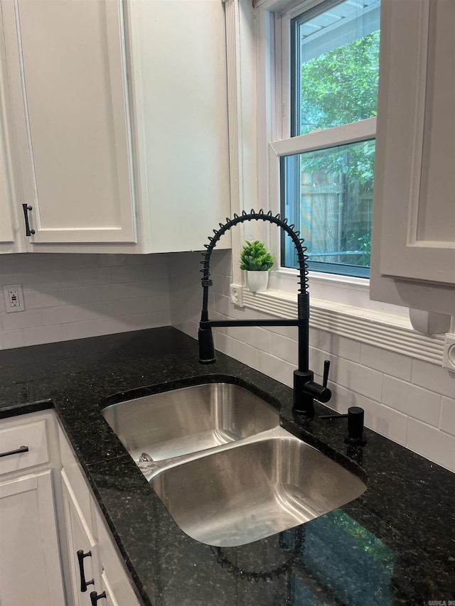 2715 Deer Xing, El Dorado, AR 71730 - kitchen view of a sink, backsplash, white cabinets, and dark stone countertops