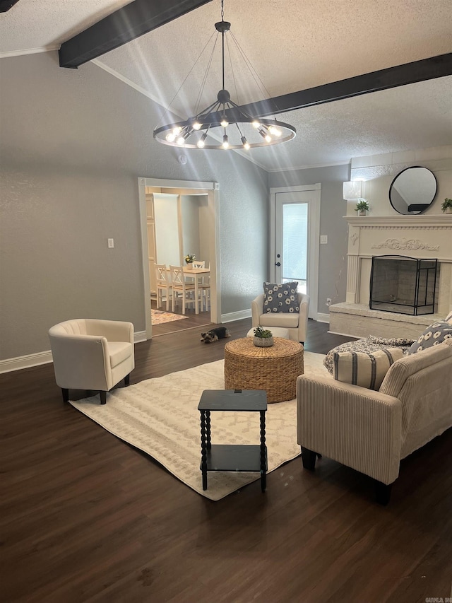 2715 Deer Xing, El Dorado, AR 71730 - living room with a chandelier, wood finished floors, baseboards, a textured ceiling, and a fireplace with raised hearth
