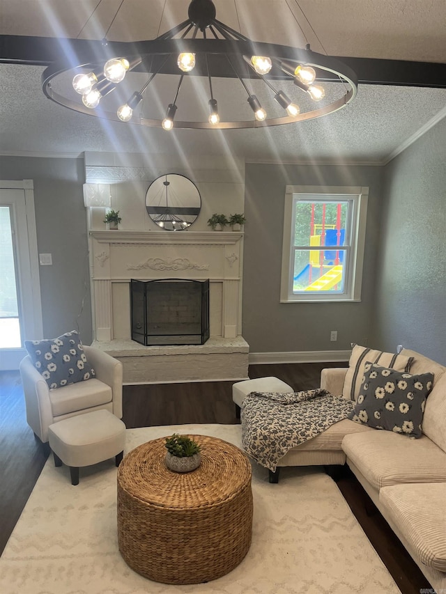 2715 Deer Xing, El Dorado, AR 71730 - living area with a textured ceiling, wood finished floors, a high end fireplace, and plenty of natural light