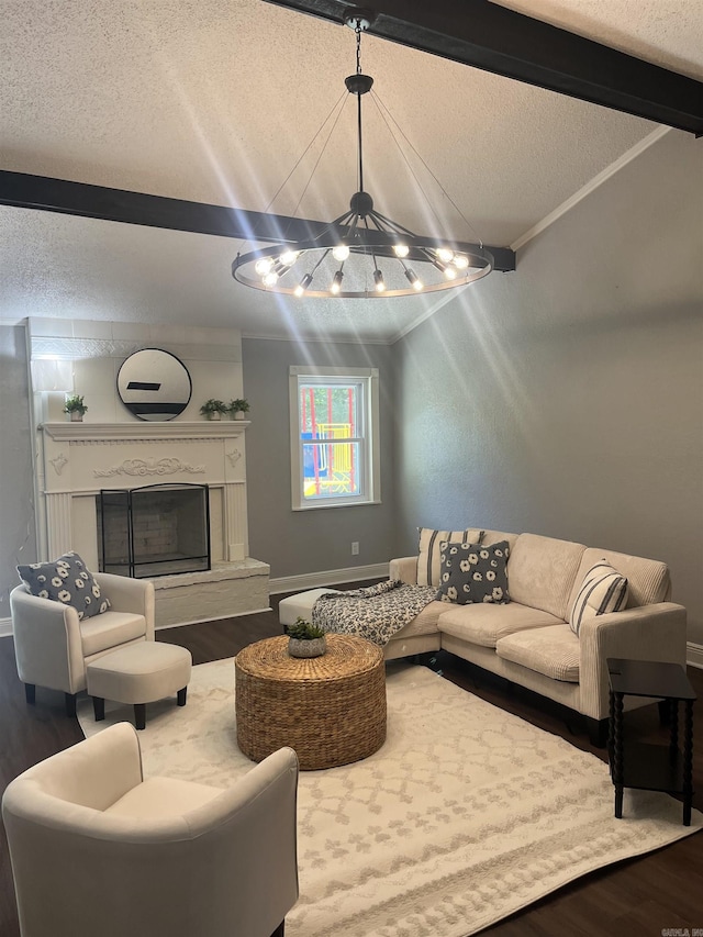 2715 Deer Xing, El Dorado, AR 71730 - living area with a chandelier, wood finished floors, a textured ceiling, a fireplace with raised hearth, and ornamental molding