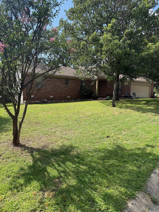 2 Flourite Ct, Little Rock, AR 72212 - view of green lawn with an attached garage