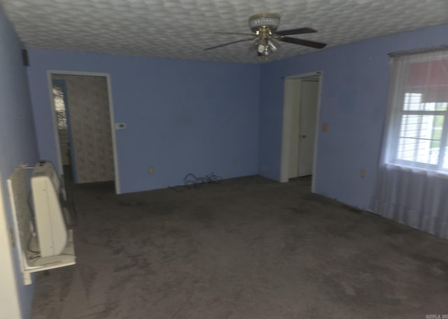 1851 W Clay, Piggott, AR 72454 - unfurnished room with ceiling fan, radiator, and carpet flooring
