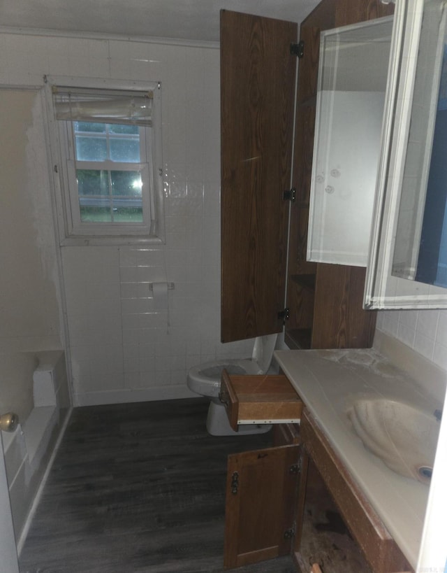1851 W Clay, Piggott, AR 72454 - bathroom with vanity, toilet, and wood finished floors