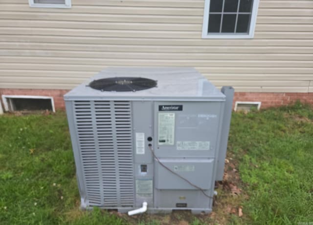 1851 W Clay, Piggott, AR 72454 - exterior view of cooling unit and crawl space