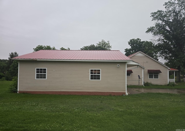 1851 W Clay, Piggott, AR 72454 - rear view of property featuring a lawn and metal roof