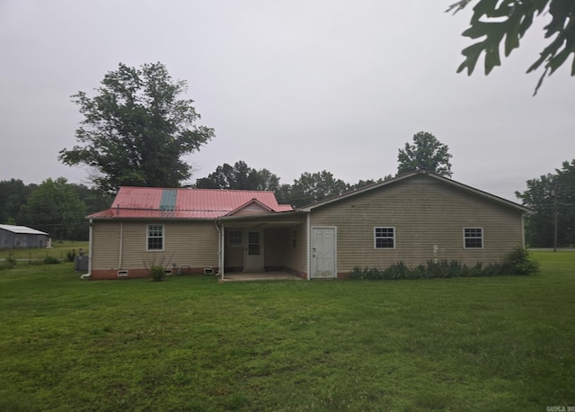 1851 W Clay, Piggott, AR 72454 - rear view of house with a yard, metal roof, and a patio