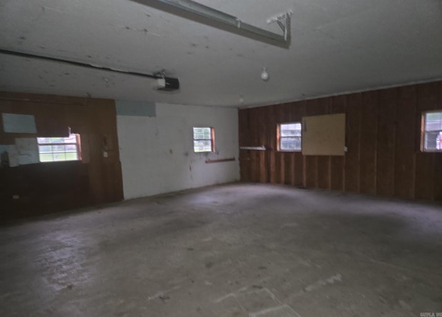 1851 W Clay, Piggott, AR 72454 - garage featuring a garage door opener and wood walls