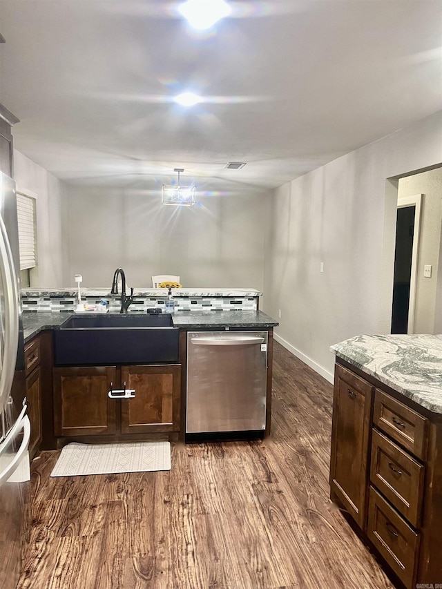 88 Cobblestone Rd, Plumerville, AR 72127 - kitchen featuring appliances with stainless steel finishes, dark wood-style flooring, dark stone counters, dark brown cabinetry, and baseboards