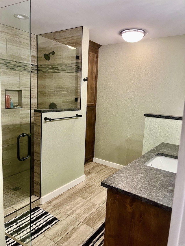 88 Cobblestone Rd, Plumerville, AR 72127 - full bathroom featuring vanity, a shower stall, baseboards, and a textured wall