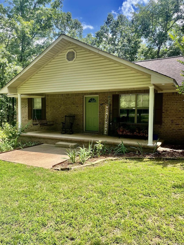 88 Cobblestone Rd, Plumerville, AR 72127 - view of front of house with a porch, a front yard, and brick siding
