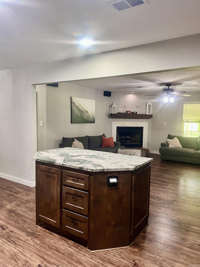 88 Cobblestone Rd, Plumerville, AR 72127 - living area featuring baseboards, dark wood-style flooring, a ceiling fan, and a fireplace
