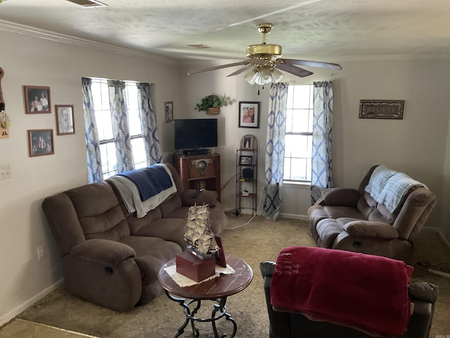 living room featuring carpet flooring, a ceiling fan, baseboards, and crown molding