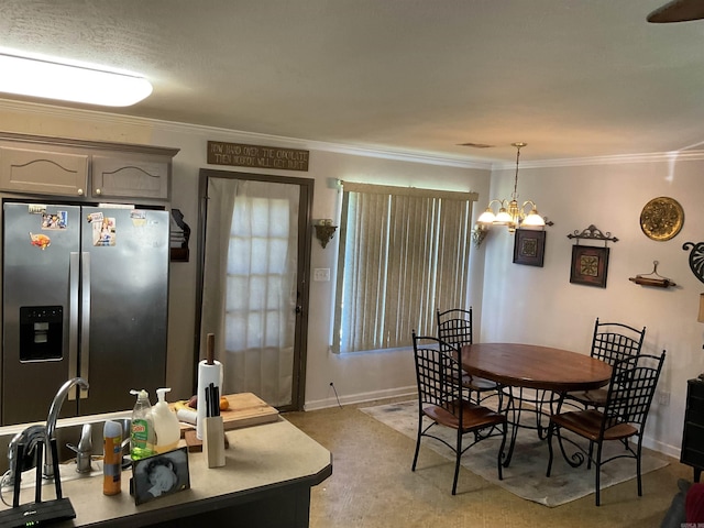 dining room with crown molding, baseboards, and a chandelier