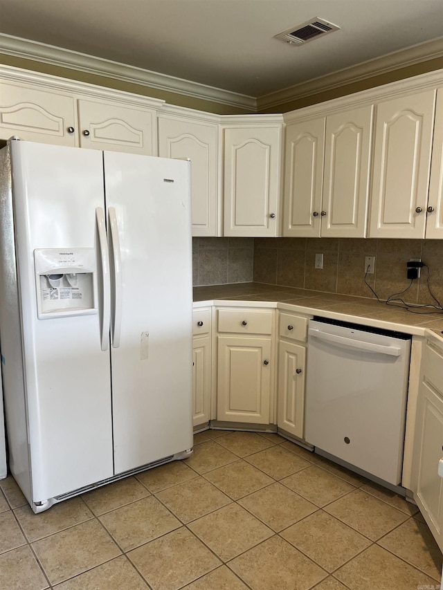 11 Willow Cv, Cabot, AR 72023 - kitchen with white appliances, light tile patterned floors, crown molding, white cabinetry, and decorative backsplash