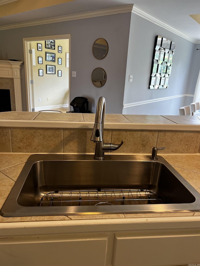 11 Willow Cv, Cabot, AR 72023 - kitchen view of ornamental molding, a sink, and a fireplace