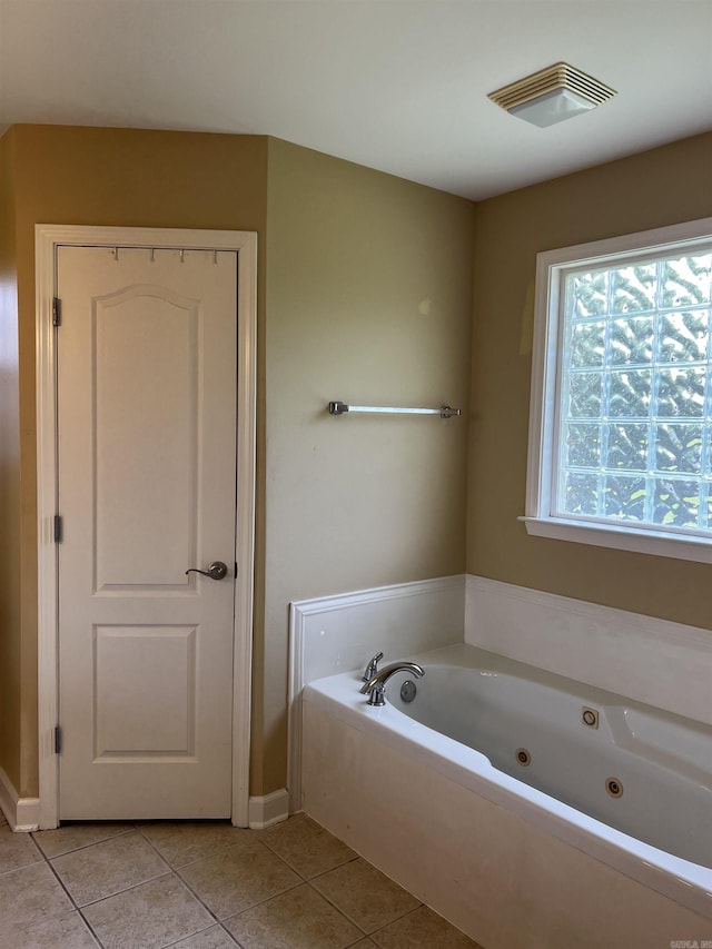 11 Willow Cv, Cabot, AR 72023 - bathroom featuring tile patterned flooring, a jetted tub, and baseboards