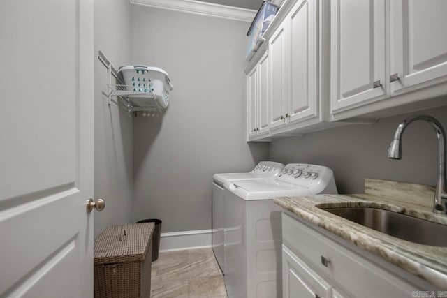 laundry room with separate washer and dryer, cabinet space, crown molding, and baseboards