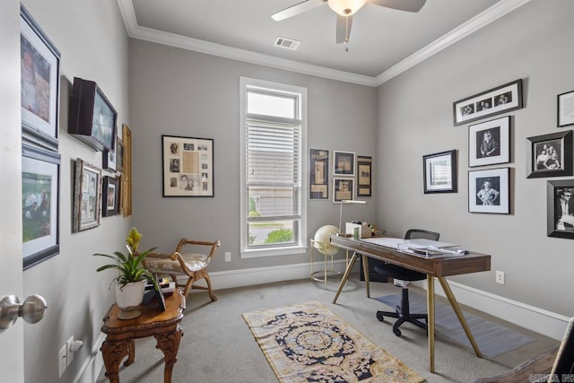 home office with light colored carpet, baseboards, crown molding, and a ceiling fan