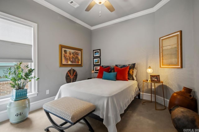 carpeted bedroom with crown molding, baseboards, and ceiling fan