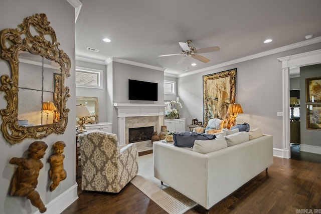 living room with ceiling fan, a fireplace, dark wood-style flooring, ornamental molding, and recessed lighting