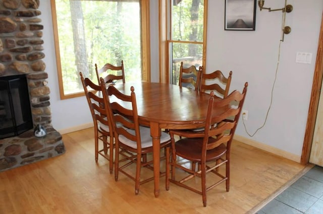 24 Roberts Rd, Edgemont, AR 72044 - dining space featuring plenty of natural light, a stone fireplace, baseboards, and light wood finished floors