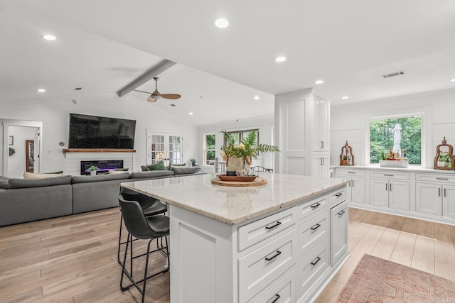 14320 Bradley Rd, Maumelle, AR 72113 - kitchen with plenty of natural light, light wood finished floors, ceiling fan, white cabinets, and recessed lighting