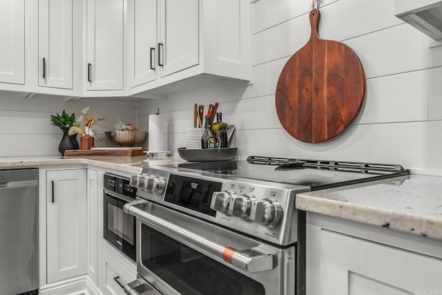 14320 Bradley Rd, Maumelle, AR 72113 - kitchen with appliances with stainless steel finishes, white cabinets, backsplash, and light stone countertops