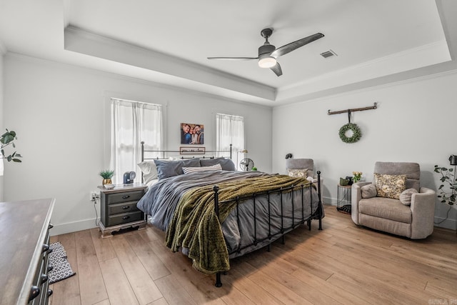 14320 Bradley Rd, Maumelle, AR 72113 - bedroom featuring a tray ceiling, light wood finished floors, ornamental molding, a ceiling fan, and baseboards