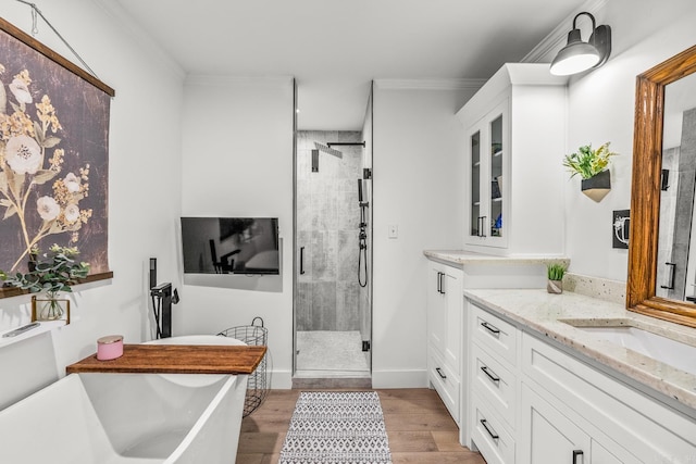 14320 Bradley Rd, Maumelle, AR 72113 - full bath featuring vanity, a stall shower, ornamental molding, a freestanding tub, and wood finished floors