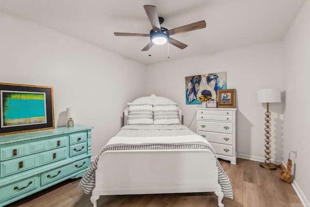 14320 Bradley Rd, Maumelle, AR 72113 - bedroom with wood finished floors, baseboards, and a ceiling fan