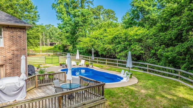 14320 Bradley Rd, Maumelle, AR 72113 - view of pool featuring outdoor dining space, view of scattered trees, a wooden deck, area for grilling, and a patio area