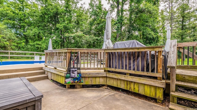 14320 Bradley Rd, Maumelle, AR 72113 - wooden terrace featuring view of scattered trees and a patio area
