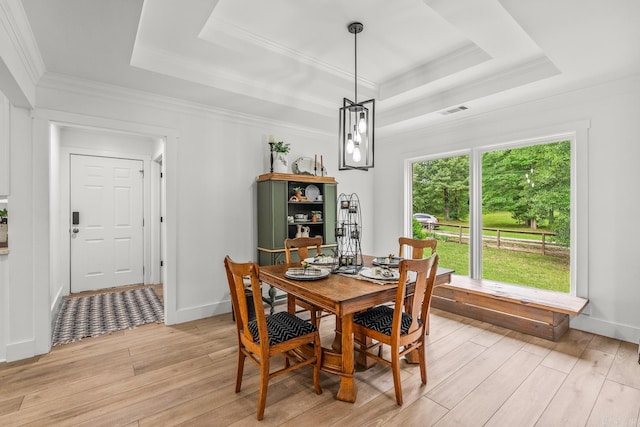 14320 Bradley Rd, Maumelle, AR 72113 - dining area with a raised ceiling, light wood finished floors, crown molding, and baseboards