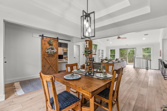 14320 Bradley Rd, Maumelle, AR 72113 - dining area featuring a barn door, light wood-style flooring, ornamental molding, ceiling fan, and baseboards