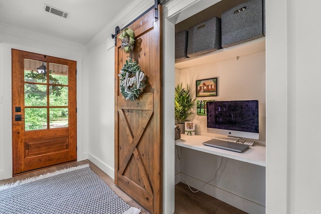 14320 Bradley Rd, Maumelle, AR 72113 - entryway featuring wood finished floors, a barn door, a desk, baseboards, and crown molding