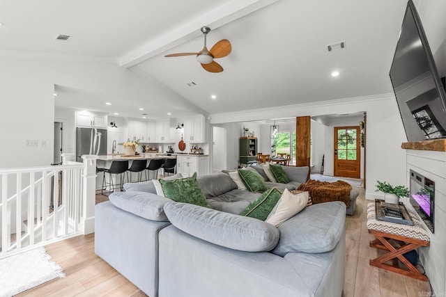 14320 Bradley Rd, Maumelle, AR 72113 - living area featuring light wood finished floors, a ceiling fan, a large fireplace, ornamental molding, and recessed lighting