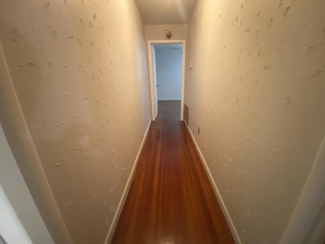 hall featuring wood finished floors and baseboards