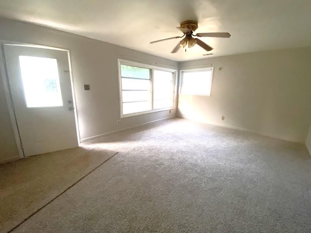 empty room with carpet floors and ceiling fan