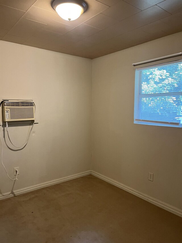 404 Rogers, Jonesboro, AR 72401 - empty room with carpet, baseboards, and an AC wall unit