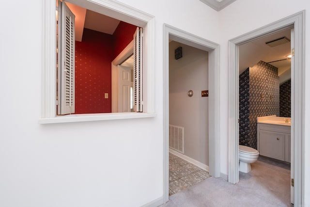 11 Bradbury Dr, Little Rock, AR 72212 - hall featuring tile patterned floors, carpet, baseboards, and a sink