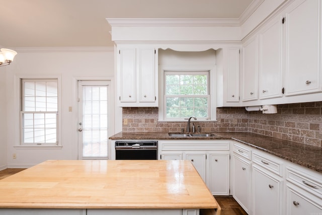 11 Bradbury Dr, Little Rock, AR 72212 - kitchen with a sink, black dishwasher, ornamental molding, white cabinetry, and decorative backsplash