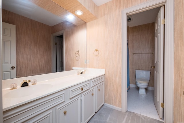 11 Bradbury Dr, Little Rock, AR 72212 - full bathroom with toilet, double vanity, baseboards, and tile patterned floors
