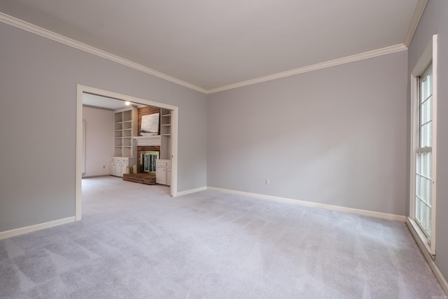 11 Bradbury Dr, Little Rock, AR 72212 - unfurnished living room featuring crown molding, baseboards, built in features, light colored carpet, and a brick fireplace