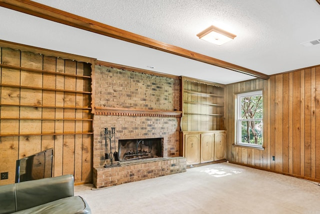17 Point S Ct, Little Rock, AR 72211 - unfurnished living room featuring wood walls, a textured ceiling, a brick fireplace, crown molding, and carpet