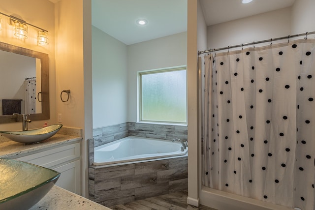 205 Capitol Cv, Jonesboro, AR 72401 - bathroom featuring vanity, a garden tub, wood finished floors, a shower with curtain, and recessed lighting
