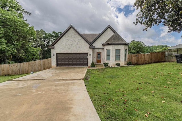 205 Capitol Cv, Jonesboro, AR 72401 - french provincial home with an attached garage, concrete driveway, and a shingled roof