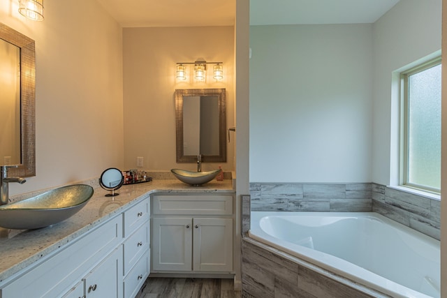 205 Capitol Cv, Jonesboro, AR 72401 - full bathroom with double vanity, a bath, and wood finished floors