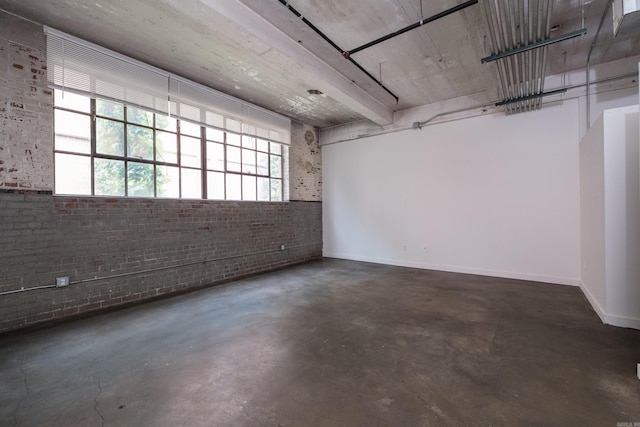 423 E 3rd St Unit 211, Little Rock, AR 72201 - spare room with concrete floors, brick wall, and baseboards