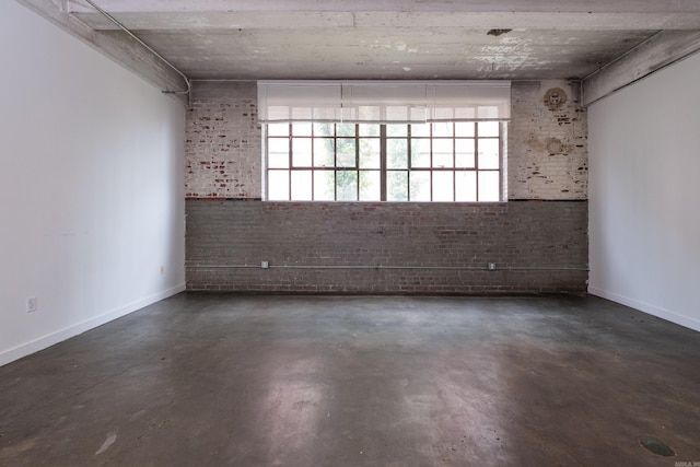 423 E 3rd St Unit 211, Little Rock, AR 72201 - unfurnished room featuring concrete flooring, brick wall, and baseboards