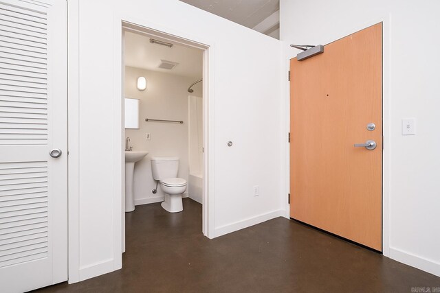 423 E 3rd St Unit 211, Little Rock, AR 72201 - full bathroom featuring finished concrete floors, toilet, baseboards, and  shower combination
